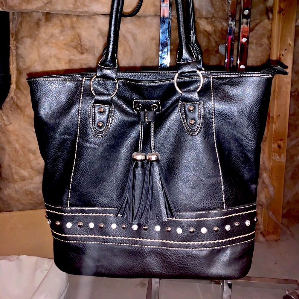 Classic black bag with silver studs and black tassels. Classy silk like lining.